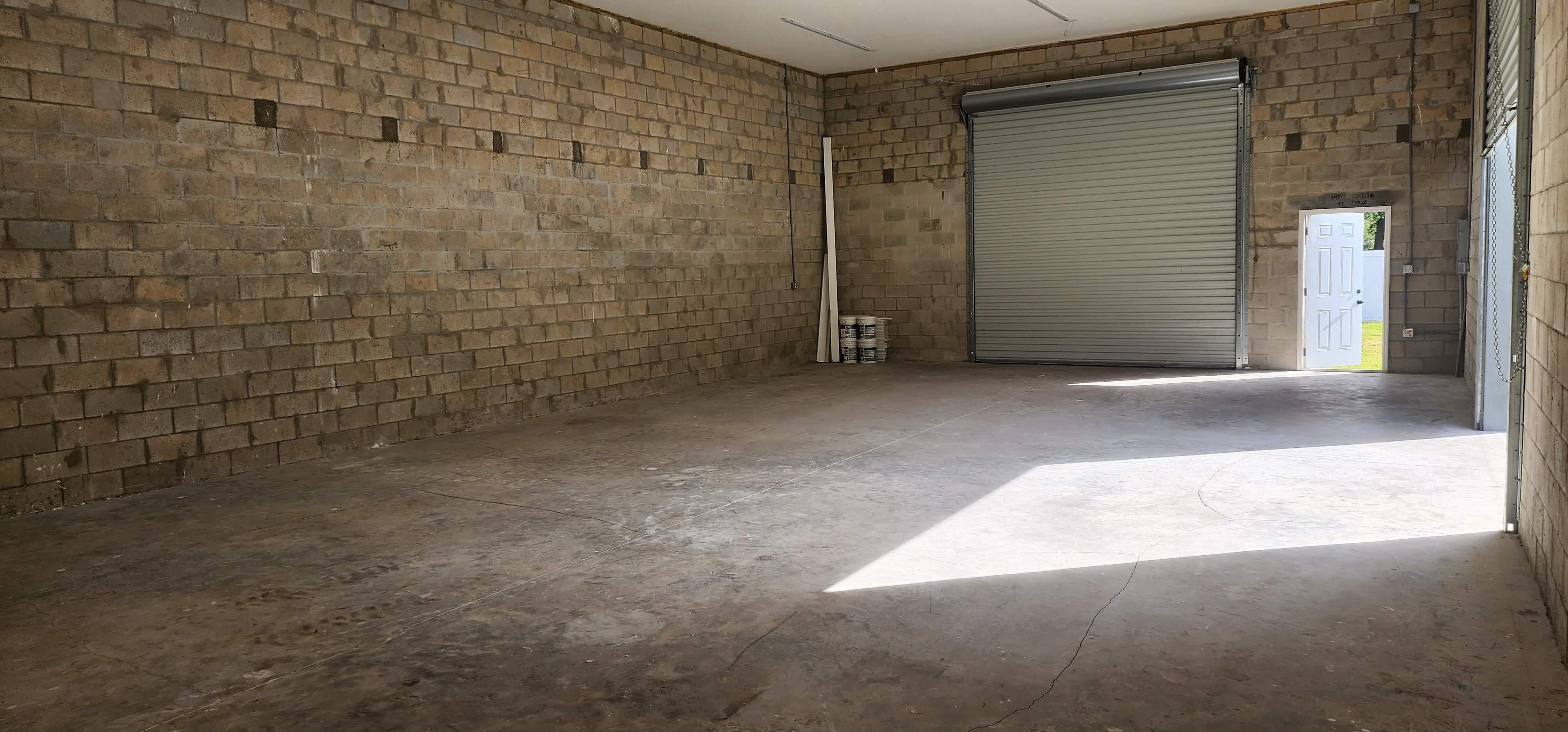 Garage floor before epoxy coating - worn concrete